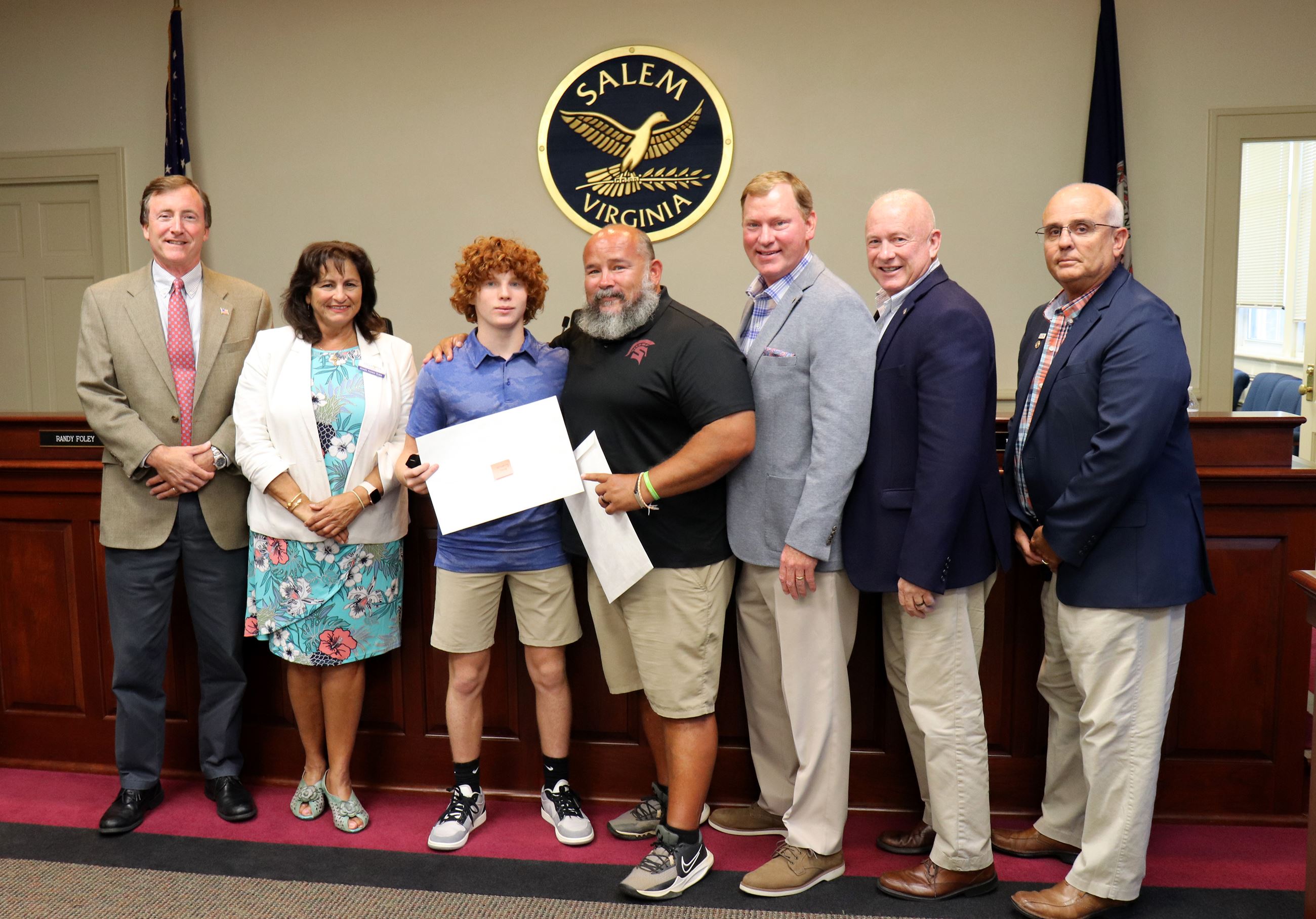 Group of folks holding a resolution